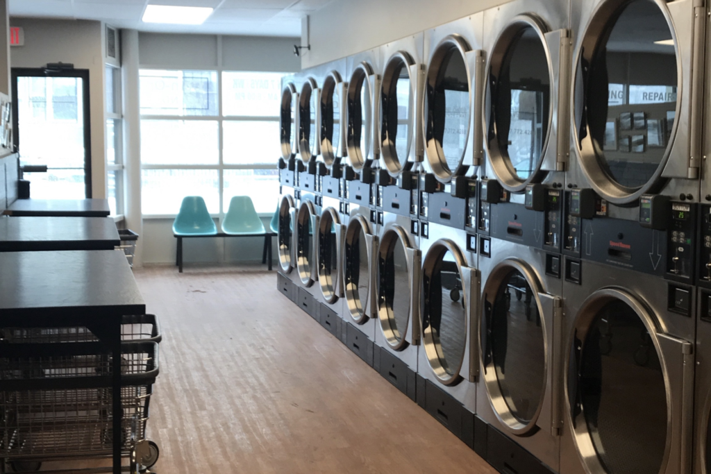 laundry pickup vs laundromat NYC comparison with delivery service and laundromat machines