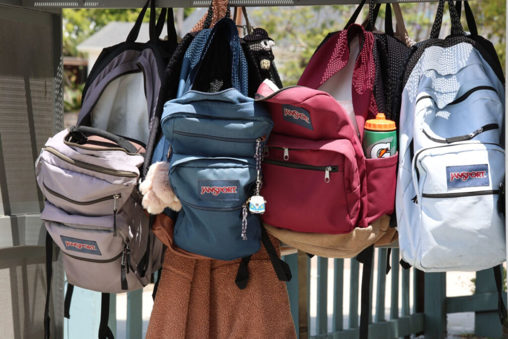 Colorful childrens backpacks ready for the NYC back to school laundry routine