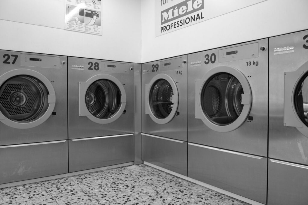 Modern NYC laundromat with commercial washing machines used for high heat bed bug treatment